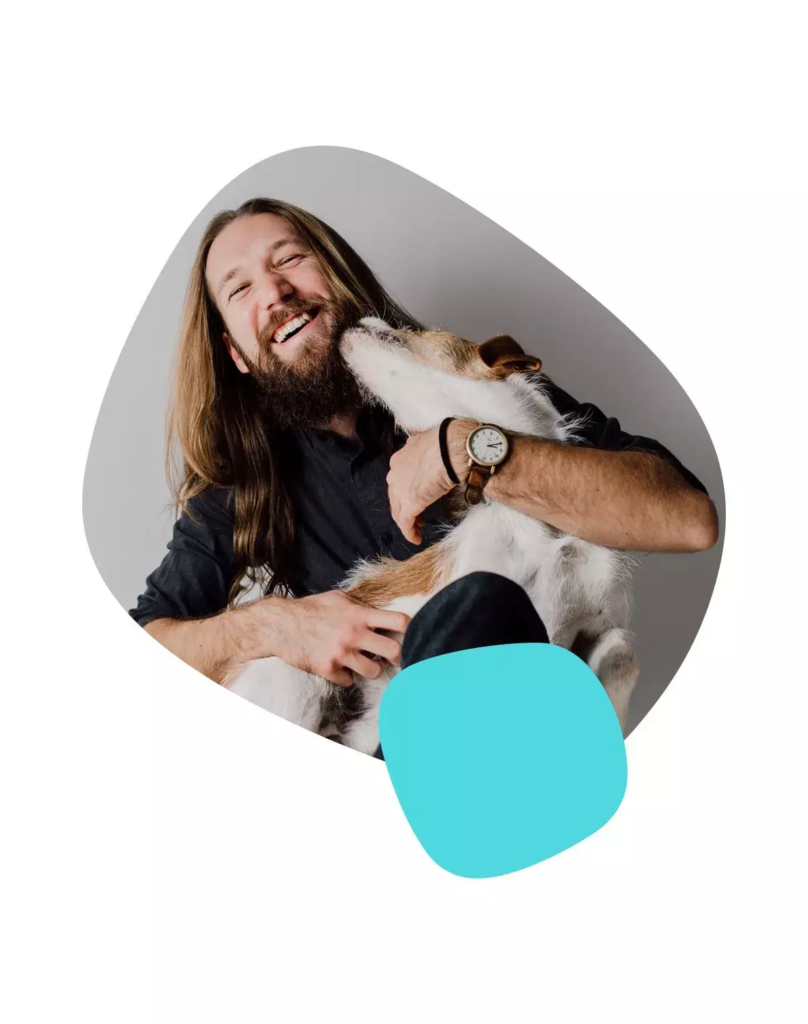 Man laughing holding his dog