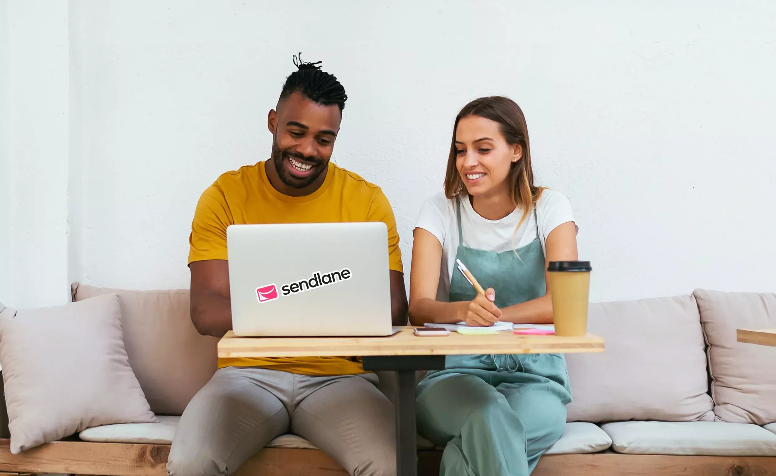 Sendlane - man and woman sitting and looking at a laptop